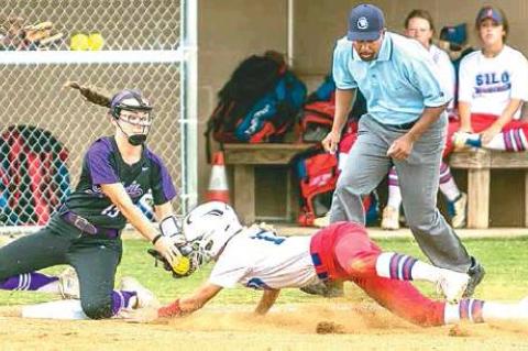 —Photo by Sherry Loudermilk CLASS 2A STATE SOFTBALL TOURNAMENT (COALGATE VS SILO) - Lady Cat sophomore shortstop Kenley Thompson #15 covers third base and tags a Silo player.