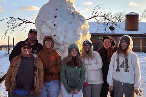 This over 10 ft. tall snowman was built at Marissa and Dee Hensley’s house in Lehigh. The builders include (l to r) Paul Cotttrell, PJ Cottrell, Sawyer Donihoo, Scout Donihoo, Kaydince Cottrell, Marissa Hensley, and Jessa Cottrell. It took some doing, but they “gotter done.”