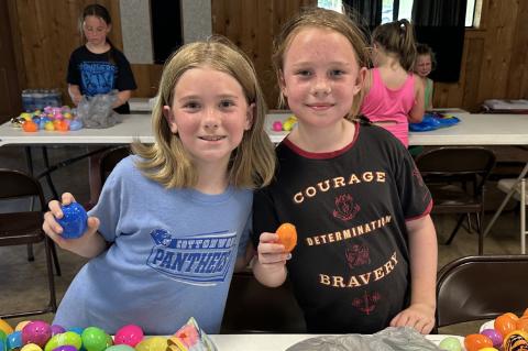 Jade Adams and Elizabeth Sandmann showing off their prize eggs from the egg hunt.