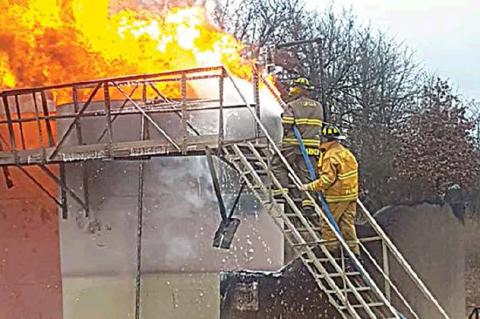 —Photo courtesy of Tupelo Fire Chief Rick Ellis                                Tupelo and Coalgate firefighters were busy fighting a lightning-strike fire at the Gulf Exploration oil pump station Friday during one of the storms that drenched Coal 