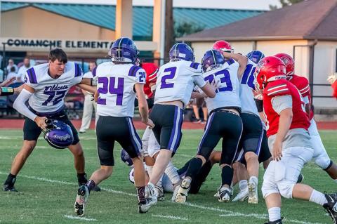 Ethan Nelson loses his helmet as the Wildcats swarm Comanche.