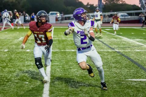 Davis Grant looks to catch a long pass from quarterback Colby Brown.